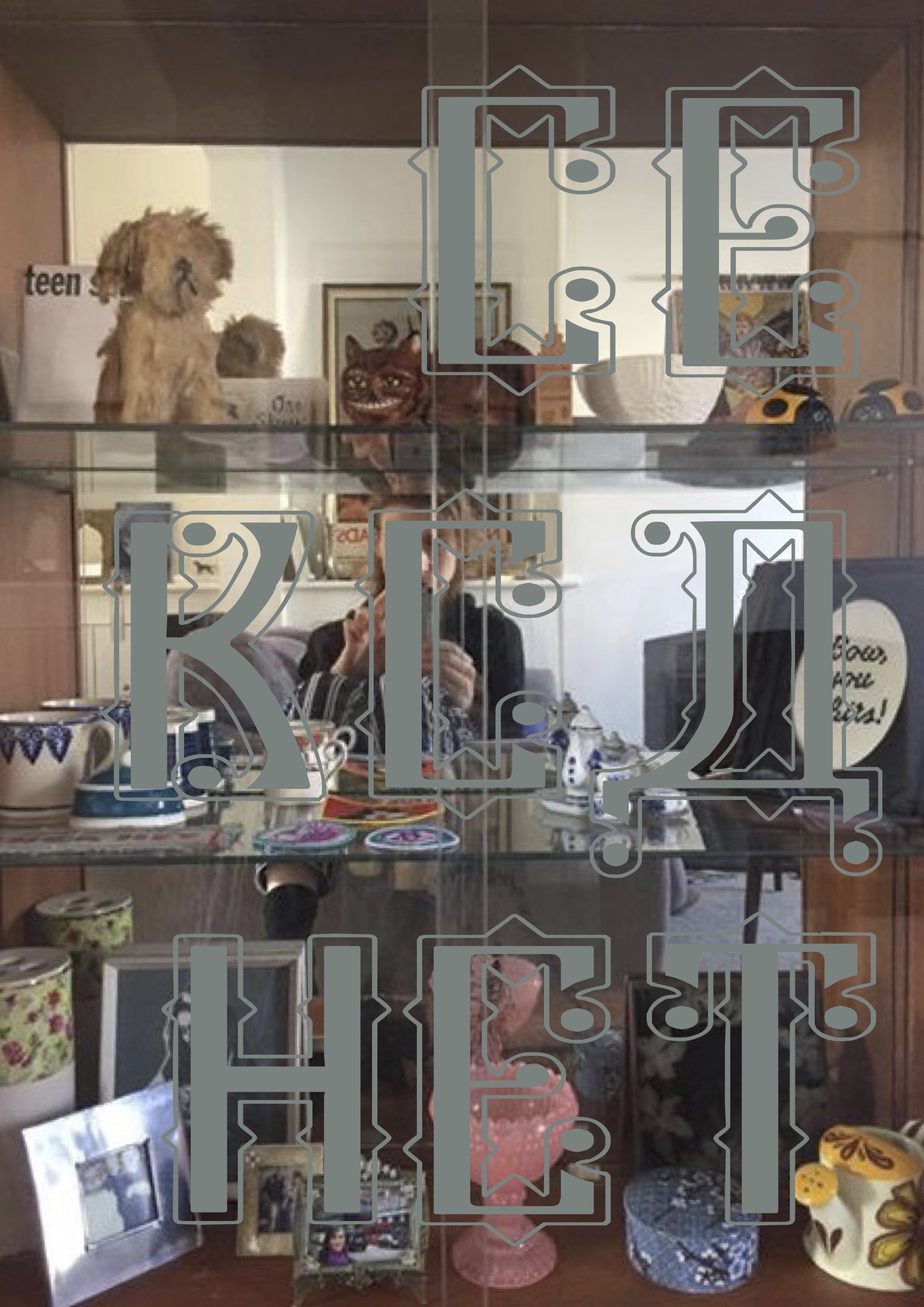 cekca het promo. An image of merchandise behind glass and reflected in mirror at back of cabinet
